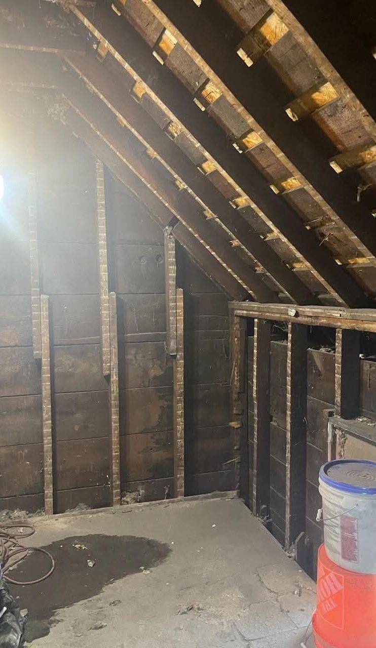Attic stripped to bare rafters and board sheathing before conversion