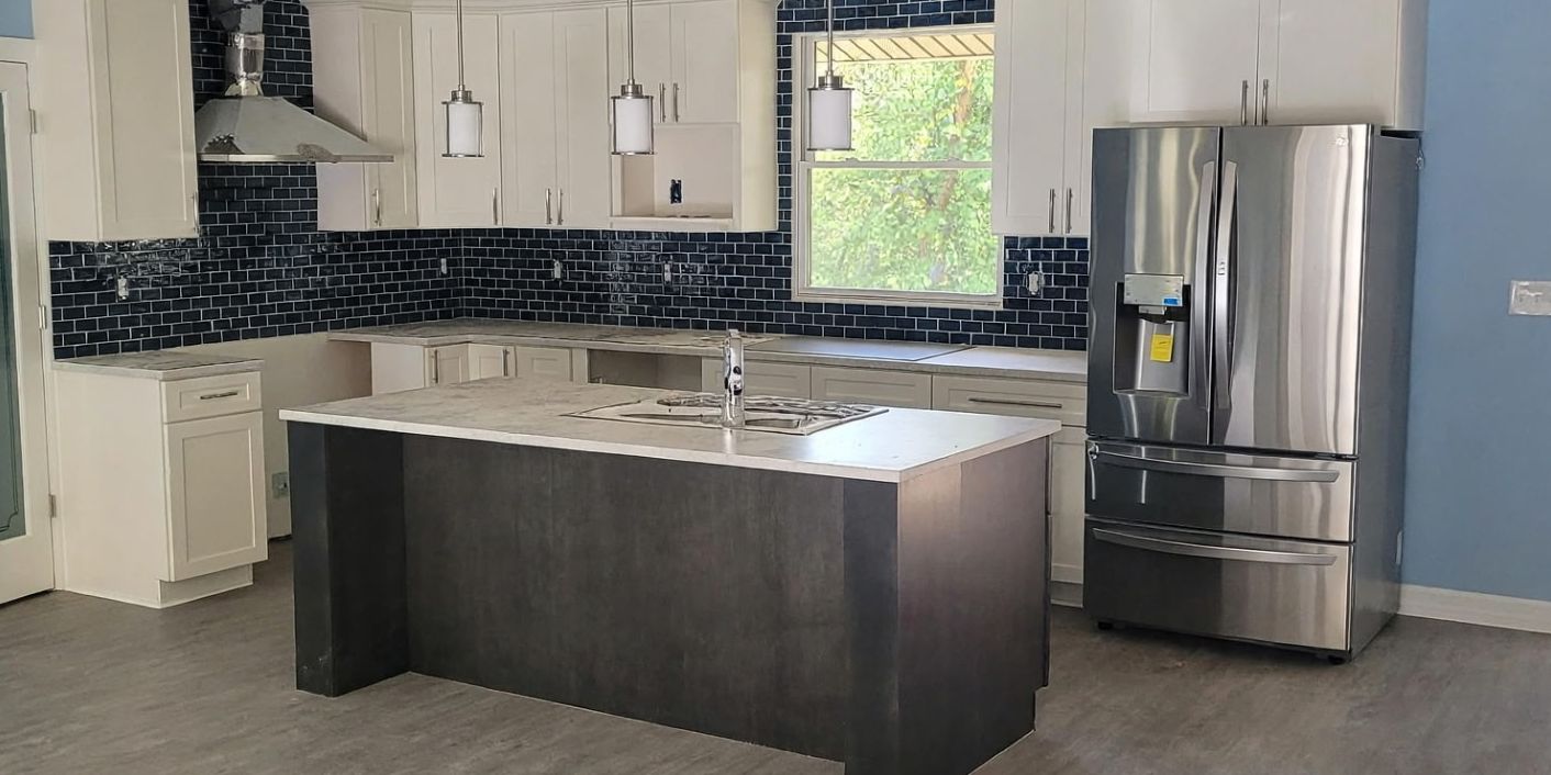 Open-concept kitchen with an island, tile backsplash and plank flooring