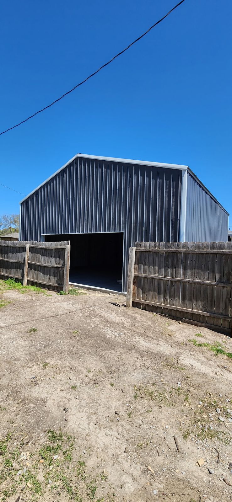 Finished steel shop building standing on the new concrete slab