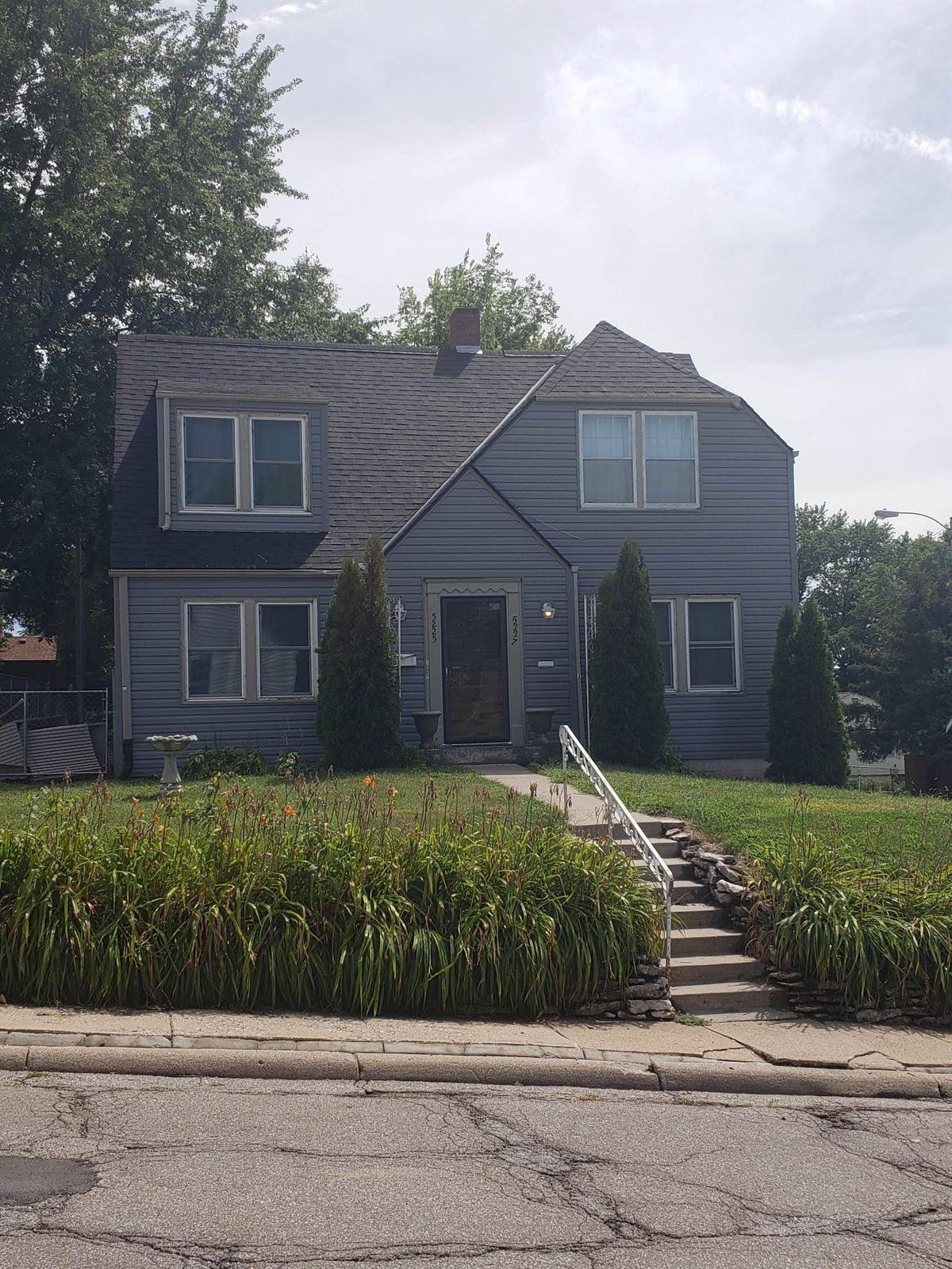 Two-storey house finished with new blue siding and white trim